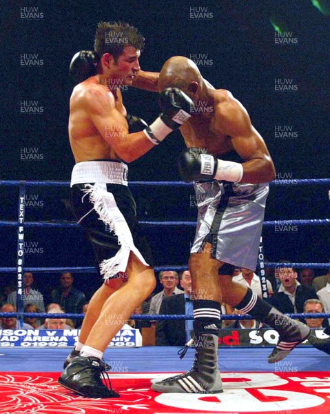 280603 - Joe Calzaghe v Byron Mitchell - WBO Super-Middleweight World Championship - Joe Calzaghe (left) and Byron Mitchell trade punches