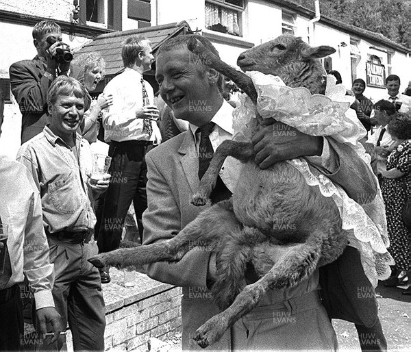 250794 - Picture shows John Bennett and his 'bride' Gerwyn the sheep being showered with confetti in Tredegar, South Wales