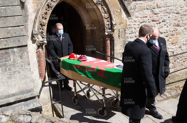 060521 - John Dawes Funeral, Llandaff Cathedral, Cardiff - The coffin of former Wales and British Lions captain and coach John Dawes is draped with a Welsh flag and accompanied by his Wales and British Lions caps as it is leaves Llandaff Cathedral, Cardiff, after his funeral service