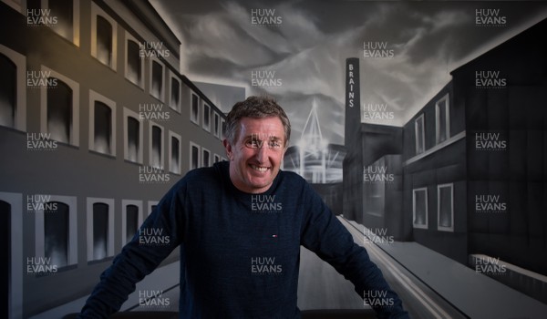 120215 - Welsh rugby legend Jonathan Davies with the mural at the TRade Street Cafe in Cardiff