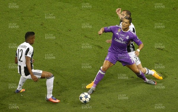 030617 - UEFA Champions League Final - Juventus v Real Madrid - Cristiano Ronaldo of Real Madrid is tackled by Giorgio Chiellini and Alex Sandro of Juventus