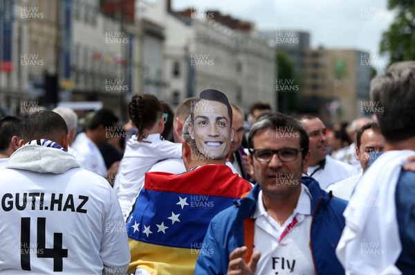 030617 - UEFA Champions League Final - Real Madrid v Juventus - A fan wears a Cristiano Ronaldo mask whilst he walks through Cardiff