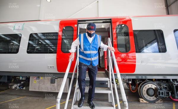 150421 Labour Leader Sir Keir Starmer MP, gets off one of the new Transport for Wales trains under construction during a visit to CAF in Newport