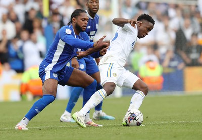 060823 - Leeds United v Cardiff City - Sky Bet Championship - Mahlon Romeo of Cardiff and Luis Sinisterra of Leeds United