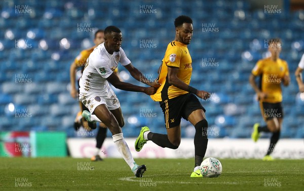 220817 - Leeds United v Newport County - Carabao Cup - Lamar Reynolds of Newport County is pulled back by Madger Gomes of Leeds United