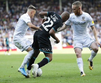 310819 - Leeds United v Swansea City - Sky Bet Championship -  Andre Ayew of Swansea is taken off the ball by Ezgjan Alioski of Leeds United and Adam Forshaw of Leeds United