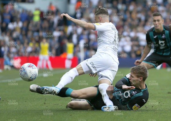 310819 - Leeds United v Swansea City - Sky Bet Championship -  Jay Fulton slides to dispossess Ezgjan Alioski of Leeds United 