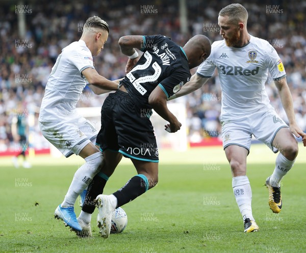 310819 - Leeds United v Swansea City - Sky Bet Championship -  Andre Ayew of Swansea is taken off the ball by Ezgjan Alioski of Leeds United and Adam Forshaw of Leeds United