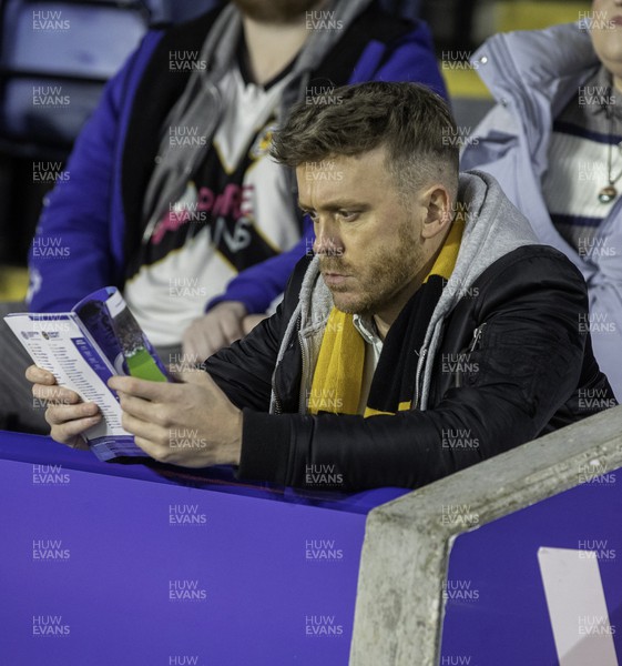 081122 - Leicester City v Newport County - Carabao Cup Third Round - A Newport fan reads the programme 