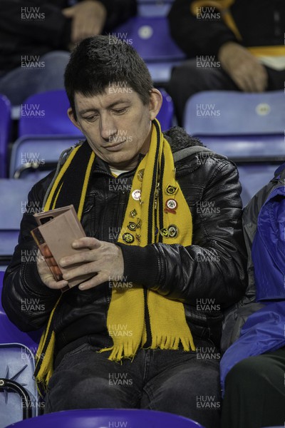 081122 - Leicester City v Newport County - Carabao Cup Third Round - A Newport fan checks his phone 