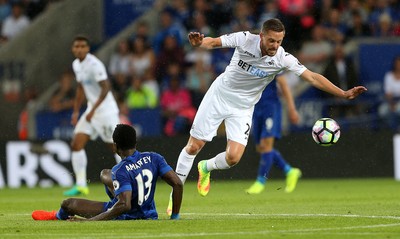 270816 - Leicester City v Swansea City - Premier League - Gylfi Sigurdsson of Swansea City goes past Daniel Amartey of Leicester