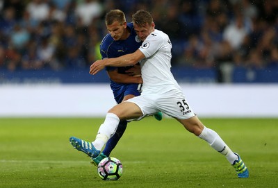 270816 - Leicester City v Swansea City - Premier League - Stephen Kingsley of Swansea City is tackled by Marc Albrighton