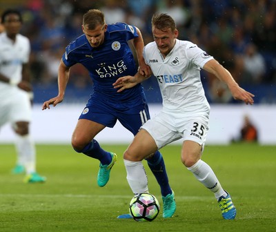 270816 - Leicester City v Swansea City - Premier League - Stephen Kingsley of Swansea City is tackled by Marc Albrighton