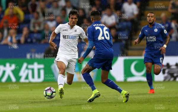 270816 - Leicester City v Swansea City - Premier League - Jack Cork of Swansea City is challenged by Riyad Mahrez of Leicester