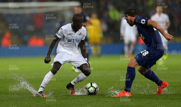 270816 - Leicester City v Swansea City - Premier League - Modou Barrow of Swansea City and Christian Fuchs of Leicester battle the conditions