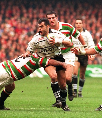 250197 - Leicester Rugby v Brive - Heineken Cup Final - Alain Penaud of Brive is tackled by Darren Garforth