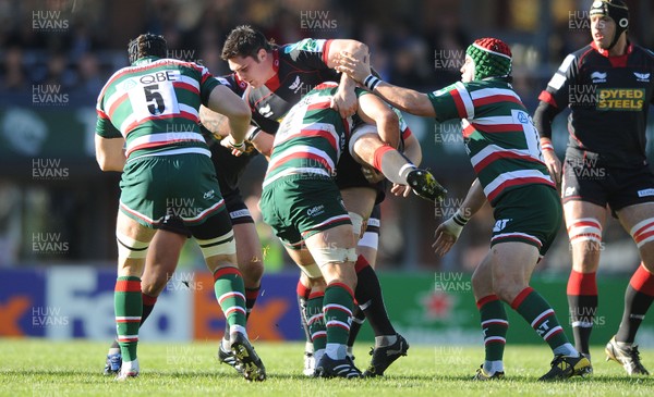 17.10.10 - Leicester Tigers v Llanelli Scarlets - Heineken Cup - Rob McCusker of Scarlets is upended. 