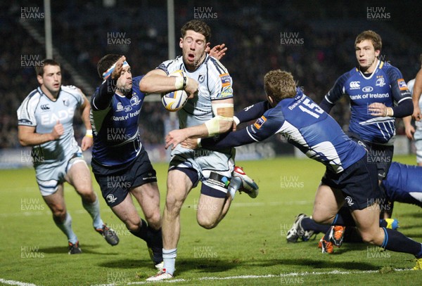 271012 Leinster v Blues - RaboDirect Pro 12 - Alex Cuthbert of Cardiff beats the tackle of Fergus McFadden and Ian Madigan of Leinster  