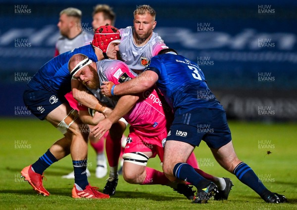 021020 - Leinster v Dragons - Guinness PRO14 - Joe Davies of Dragons is tackled by Josh van der Flier and Michael Bent of Leinster