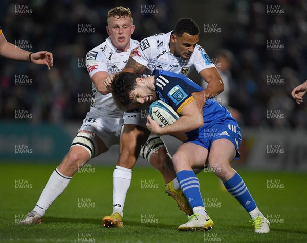 180223 - Leinster v Dragons RFC - United Rugby Championship - Harry Byrne of Leinster is tackled by Ashton Hewitt, centre, and Ben Fry of Dragons