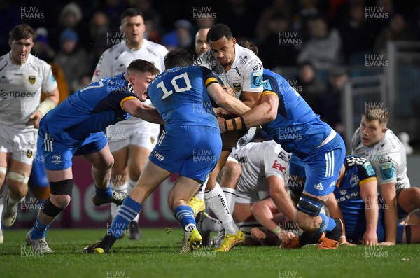 180223 - Leinster v Dragons RFC - United Rugby Championship - Ashton Hewitt of Dragons is tackled by Leinster players from left, Jack Boyle, Harry Byrne, and Jason Jenkins