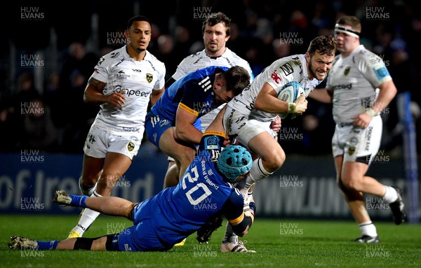 180223 - Leinster v Dragons RFC - United Rugby Championship - Steff Hughes of Dragons is tackled by Will Connors, bottom, and Lee Barron of Leinster