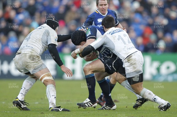 21.01.12 - Leinster v Montpellier - Heineken Cup Mike Ross of Leinster tackled by Hendrikus Hancke and Paul Bosch of Montpellier  