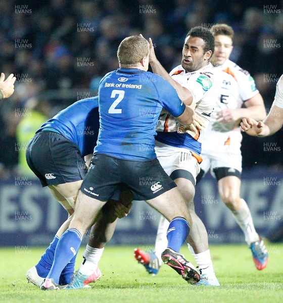 170114 - Leinster v Ospreys - Heineken European Cup - Aisea Natoga of Ospreys is tackled by Jamie Heaslip and Sean Cronin of Leinster