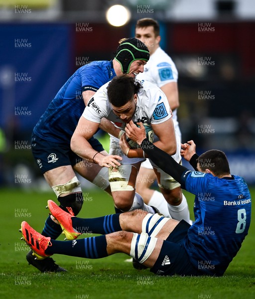 190222 - Leinster v Ospreys - United Rugby Championship - Ethan Roots of Ospreys is tackled by Ryan Baird, left, and Max Deegan of Leinster