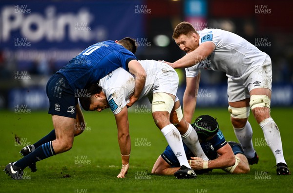 190222 - Leinster v Ospreys - United Rugby Championship - Ethan Roots of Ospreys is tackled by Ross Byrne, left, and Ryan Baird of Leinster