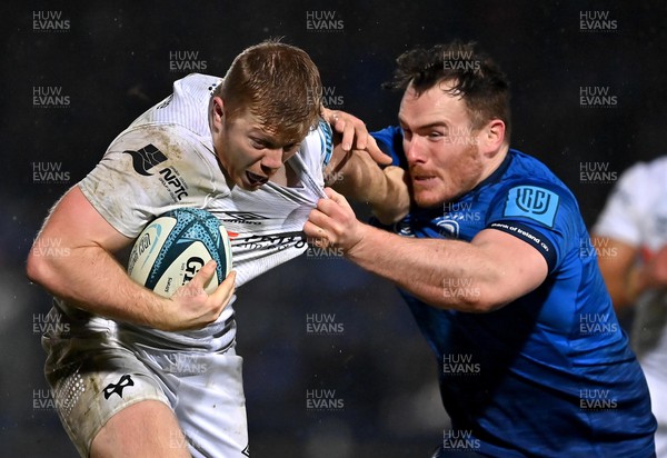 190222 - Leinster v Ospreys - United Rugby Championship - Kieran Williams of Ospreys is tackled by Peter Dooley of Leinster