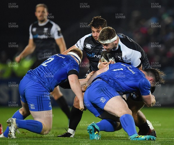 231118 - Leinster v Ospreys - Guinness PRO14 -   Rhodri Jones of Ospreys is tackled by James Tracy, left, and Peter Dooley of Leinster 