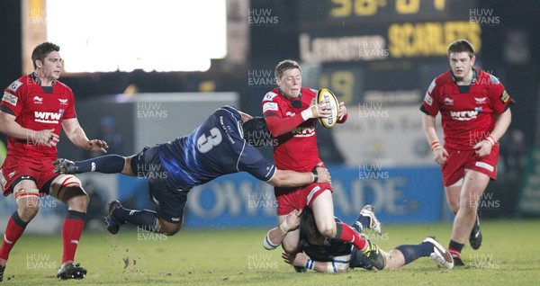 04.03.11.Leinster v Scarlets. Rhys Priestland of Scarlets tackled by Stan Wright and Rhys Ruddock.  