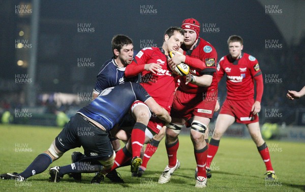 04.03.11.Leinster v Scarlets. Daniel Evans of Scarlets tackled by Kevin McLaughlin and Nathan Hines of Leinster.  