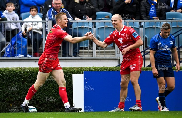 161021 - Leinster v Scarlets - United Rugby Championship - Johnny McNicholl of Scarlets, left, is congratulated by team-mate Ioan Nicholas after scoring their side's first try