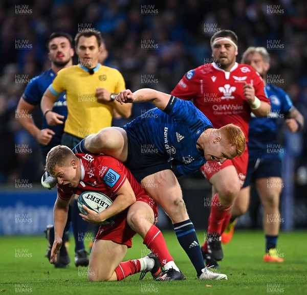 161021 - Leinster v Scarlets - United Rugby Championship - Sam Costelow of Scarlets is tackled by Ciaran Frawley of Leinster