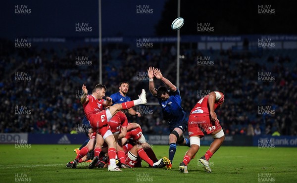 161021 - Leinster v Scarlets - United Rugby Championship - Gareth Davies of Scarlets executes a box kick, under pressure from James Ryan of Leinster