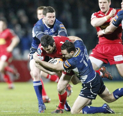 170212 - Leinster v Scarlets - RaboDirect Pro12 -Scarlets' Stephen Jones is tackled by Leinster's Fergus McFadden and David Kearney