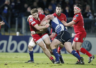 170212 - Leinster v Scarlets - RaboDirect Pro12 -Scarlets' Rhordri Jones is tackled by Leinster's Jack McGrath and Damian Browne