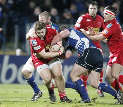 170212 - Leinster v Scarlets - RaboDirect Pro12 -Scarlets' Rhordri Jones is tackled by Leinster's Jack McGrath and Damian Browne