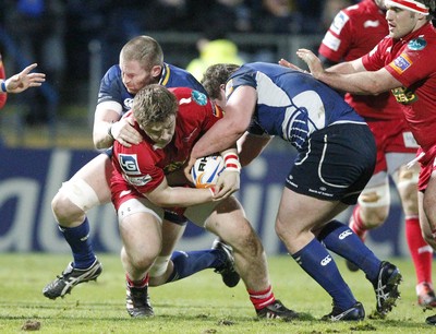 170212 - Leinster v Scarlets - RaboDirect Pro12 -Scarlets' Rhordri Jones is tackled by Leinster's Jack McGrath and Damian Browne