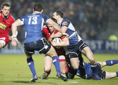 170212 - Leinster v Scarlets - RaboDirect Pro12 -Scarlets' Andy Fenby istackled by Leinster's David Kearney and Fergus McFadden