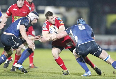 170212 - Leinster v Scarlets - RaboDirect Pro12 -Scarlets' Gareth Davies is tackled by Leinster's Kevin McLaughlin and Rhys Ruddock