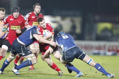 170212 - Leinster v Scarlets - RaboDirect Pro12 -Scarlets' Gareth Davies is tackled by Leinster's Kevin McLaughlin and Rhys Ruddock