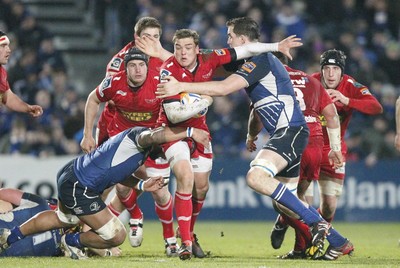 170212 - Leinster v Scarlets - RaboDirect Pro12 -Scarlets' Gareth Maule is tackled by Leinster's Devin Toner and Leo Auva'a