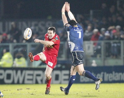 170212 - Leinster v Scarlets - RaboDirect Pro12 -Scarlets' Stephen Jones kicks as Leinster's Shane Jennings challenges