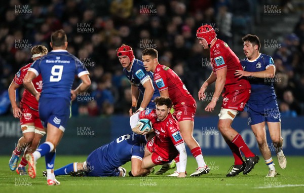 181123 - Leinster v Scarlets - United Rugby Championship - Tom Rogers of Scarlets is tackled by Max Deegan of Leinster