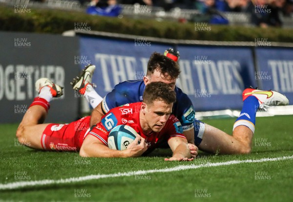 181123 - Leinster v Scarlets - United Rugby Championship - Kieran Hardy of Scarlets is tackled by Hugo Keenan of Leinster