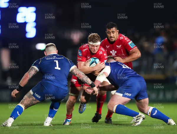 181123 - Leinster v Scarlets - United Rugby Championship - Ben Williams of Scarlets is tackled by Andrew Porter, left, and Tadhg Furlong of Leinster