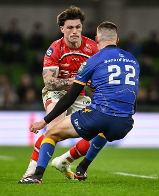 270326 - Leinster v Scarlets - United Rugby Championship - Joe Roberts of Scarlets is tackled by Sam Prendergast of Leinster 